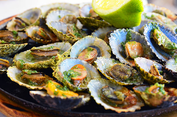 Seafood.Grilled limpets.Madeira's traditional dish. stock photo