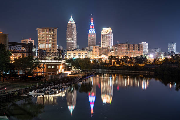 Cleveland Night Skyline Cleveland city skyline at night across the Cuyahoga river cuyahoga river photos stock pictures, royalty-free photos & images