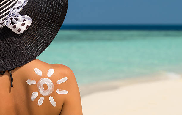 istock Woman with sun-shaped sun cream 615749362