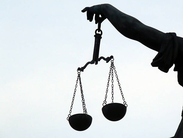 istock Left Side Hand Of Lady Justice Holding Weight Scale View 615749586