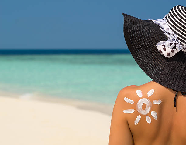 istock Woman with sun-shaped sun cream 615749758