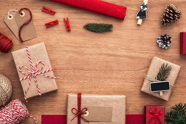 istock Christmas background with copy space. Wooden desk with presents. 615749862