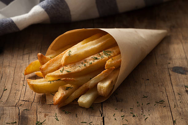 istock fries french herb still life wood background 615794734