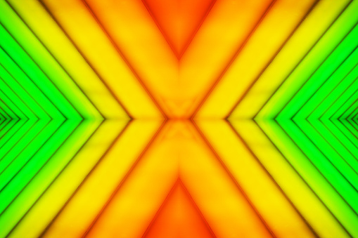 Abstract orange-to-green color gradient of repetitive converging parallel diagonal lines with mirrored symmetry.