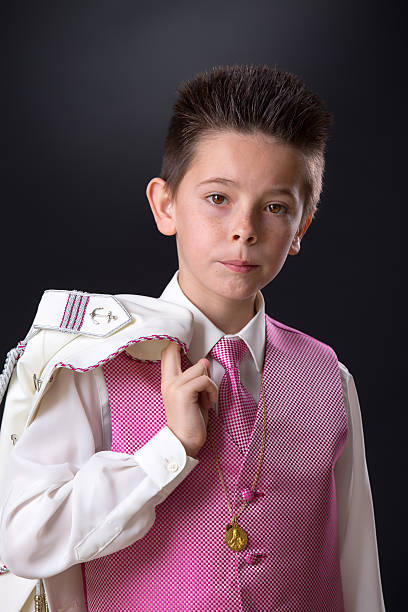 istock Young boy holding his jacket over his shoulder 615796374