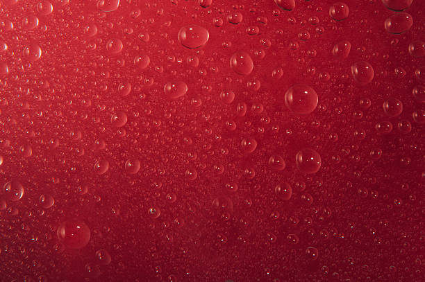 istock Texture of water drops in red background 615796888