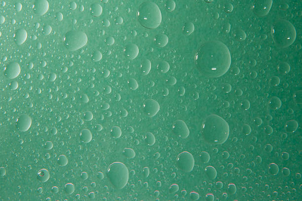 istock Texture of water drops in green background 615796948