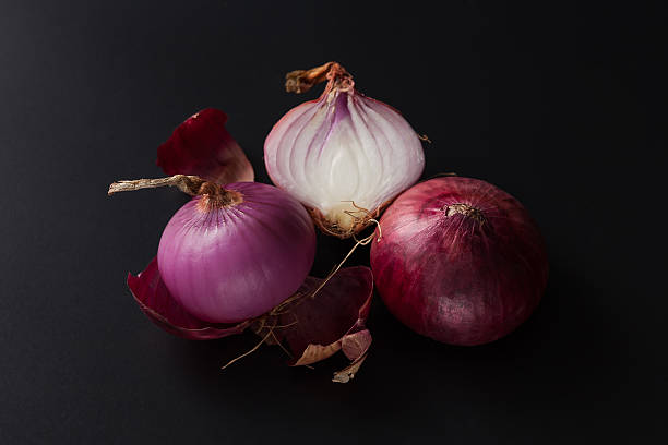 istock shallots still life black background 615799386