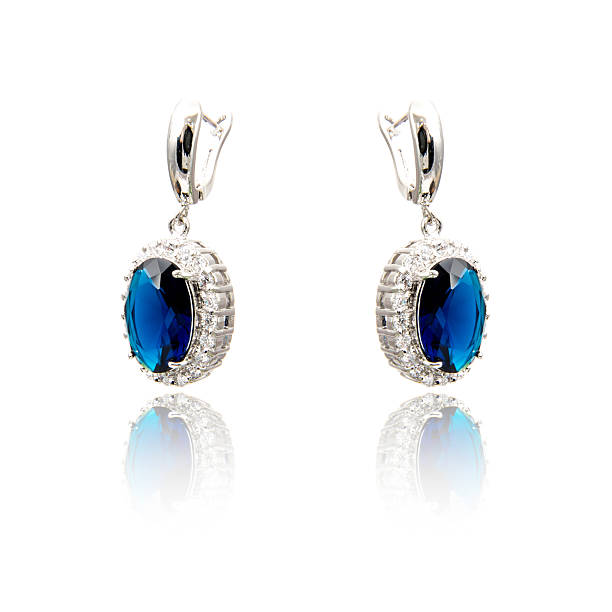 istock Pair of sapphire earrings isolated on white 615799910