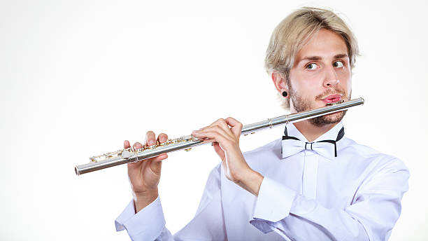 istock Male flutist playing his flute 615800290