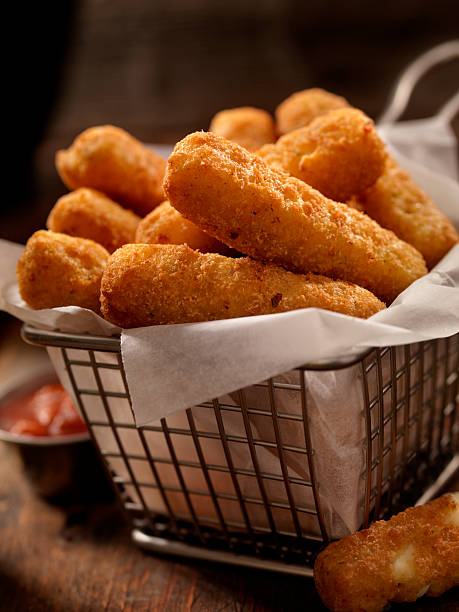 Basket of Mozzarella Cheese Sticks Basket of Mozzarella Cheese Sticks -Photographed on Hasselblad H3D2-39mb Camera CHEESE STICKS stock pictures, royalty-free photos & images