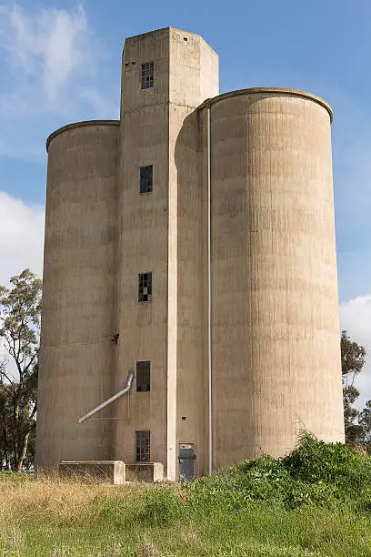 Grain silos on the railway line in the tiny rural village of Tallygaroopna, New South Wales, Australia