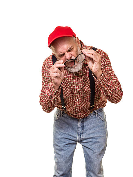 istock Visually Impaired Redneck Hillbilly Man Examining Eyeglasses 615804348