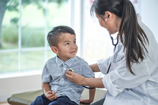 istock Doctor Checking a Boy's Heartbeat 615806328