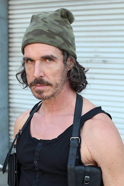 istock Mature rebel rocker on industrial setting 615806406