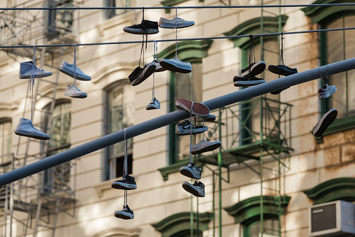 New York, USA - October 5, 2016: Vans shoes hanging on a light pole outside the Vans store in Lower Manhattans SoHo neighborhood late in the day.