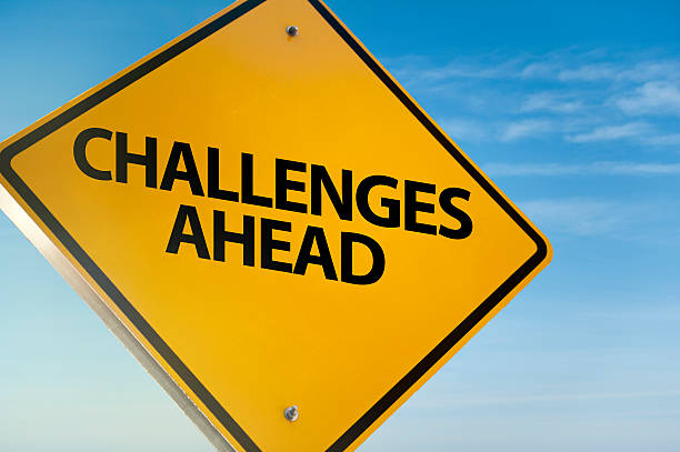 challenges ahead / traffic sign (click for more) - problems adversity conquering adversity roadblock imagens e fotografias de stock