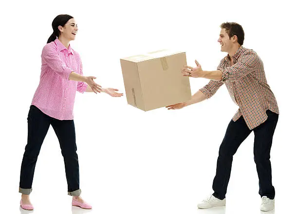 Photo of Smiling couple passing box