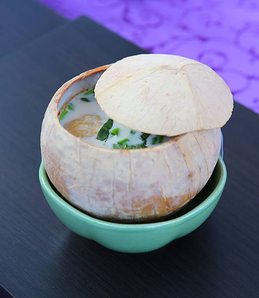 chicken and coconut traditional soup in Coconut shell