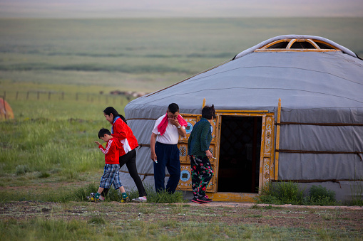 Mandalgovi, Mongolia - July 5, 2016: A few early risers walk around a Mongolian ger in the morning near Mandalgovi in the Middle Gobi region.