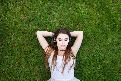 enjoy the music, top view of young woman in headphones, background