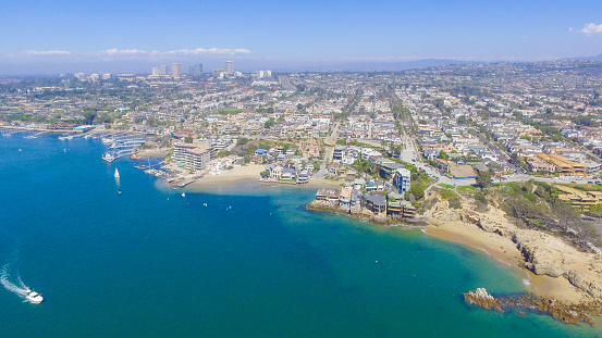 A view of the 'wedge' in Newport Beach and Newport Harbor, Southern California. The Wedge is a jetty that protects the Newport Harbor, as waves approach, the jetty funnels waves into double, even triple their size to create a unique and internationally popular surf destination.