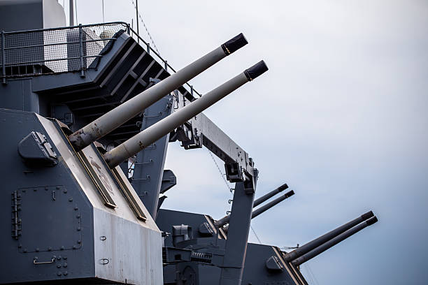 Shot of the battleship USS Alabama, docked in Mobile, AL, taken from just in front of the main guns. Focus is on the tip of the middle gun barrel.