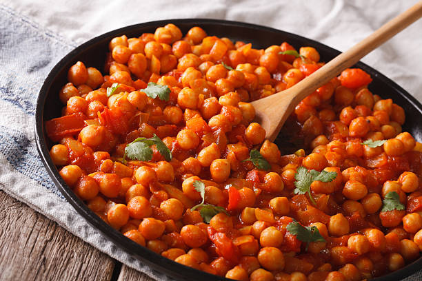 istock Indian chickpeas in tomato sauce with spices close-up. Horizontal 615816550
