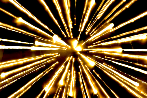 yellow light, long exposure spread light,bombs from center with black background 