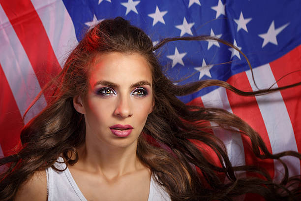 istock Girl on a background of US flag 615817384