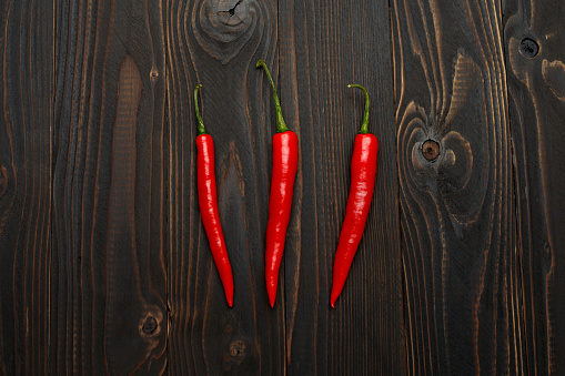 fresh chili pepper isolated on wooden background