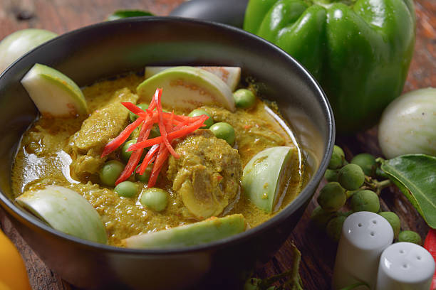 istock Thai chicken green curry with old wooden background 615818152