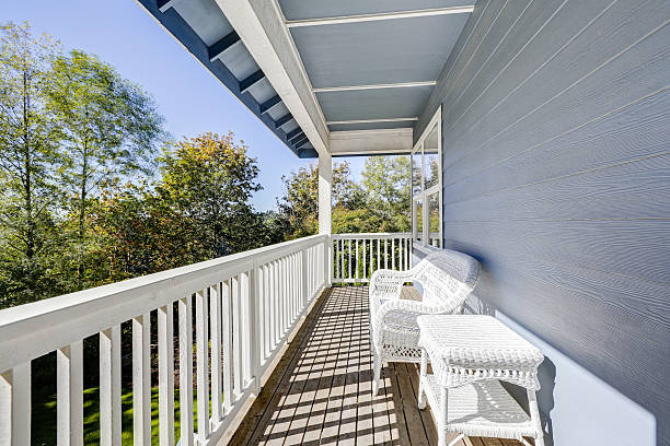 istock Sunny walkout deck with white wicker furniture 615823372