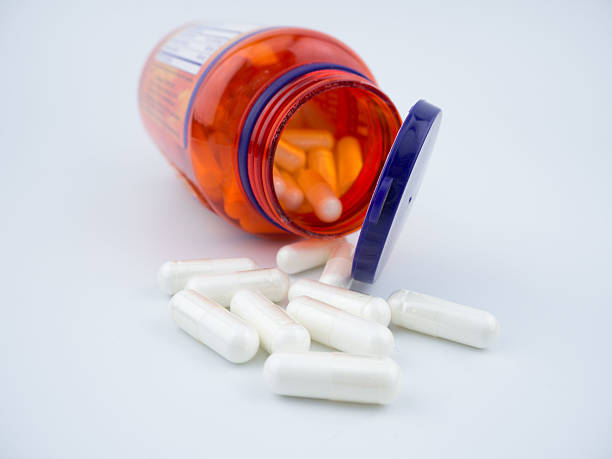 istock Vitamin supplement pill capsules on white background 615823854