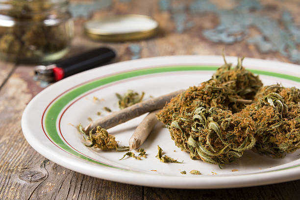 istock Marijuana buds and joints in the white plate 615824246