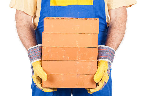 Worker with Several Bricks stock photo