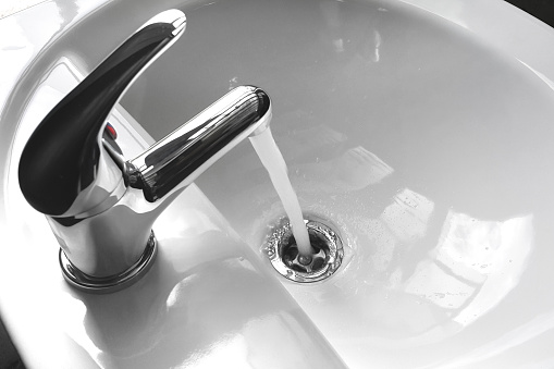 istock Faucet with Running Water in a Sink 615825008