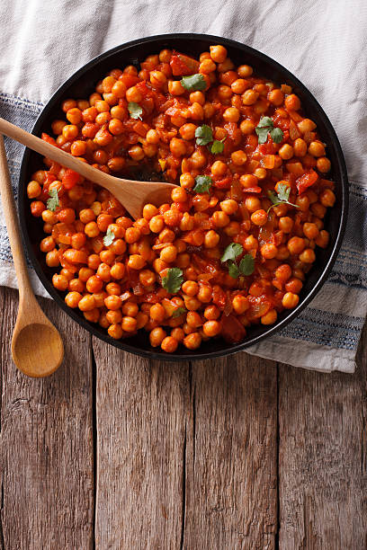 istock Indian Food: chickpeas in curry sauce. Vertical top view 615825352