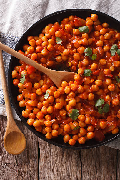 istock Indian Food: chickpeas in curry sauce close-up. Vertical top view 615825670