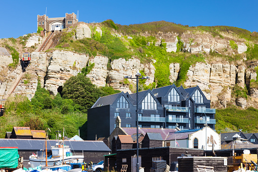 Beachside buildings with Hastings East Cliff Funicular Railway above. East Sussex England UK Europe