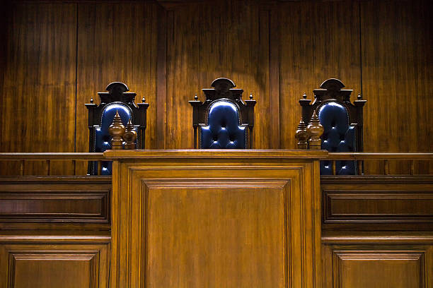 istock Empty bench with judge chairs in courtroom 615826746
