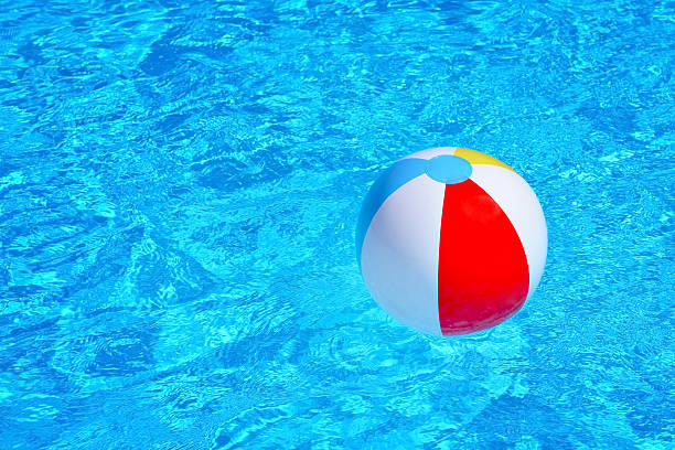 istock Colorful inflatable ball floating in swimming pool 615827224