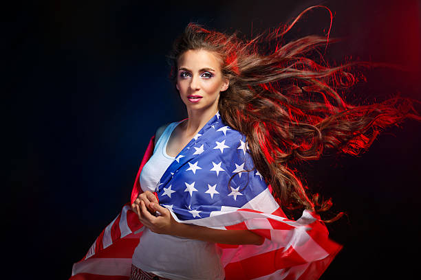 istock Girl wrapped in US flag 615827784