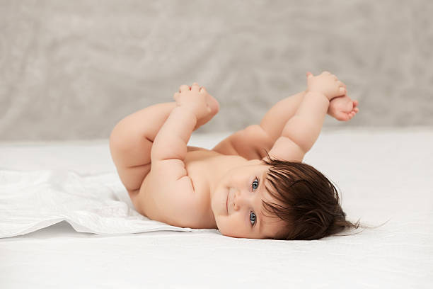 istock Baby girl lying on blanket indoors 615828352