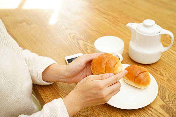 Young Asian woman having a breakfast in her room
