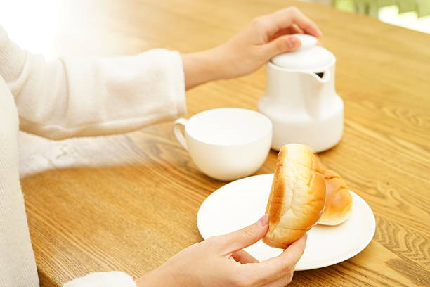 Young Asian woman having a breakfast in her room