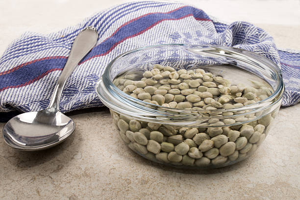 dried peas in a glass bowl with water