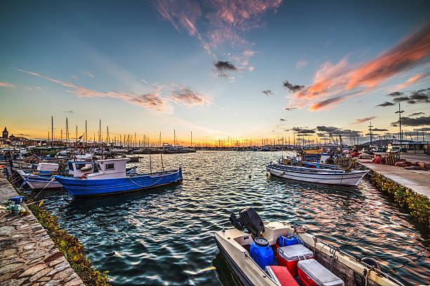 istock boats in Alghero harbor at dusk 615829870