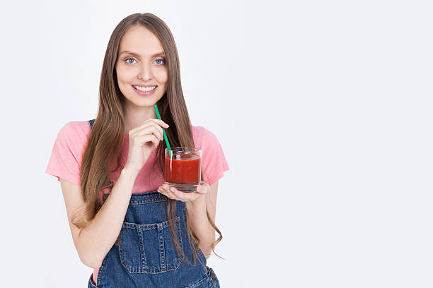 istock Cheerful girl with tomato juice 615830026