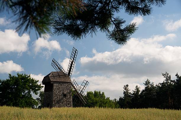 istock wooden windmill standing in the middle of fields 615831532